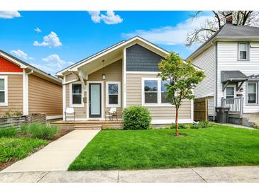 Charming bungalow with a freshly cut lawn and cozy front porch sitting area, perfect for enjoying the outdoors at 829 Olive St, Indianapolis, IN 46203