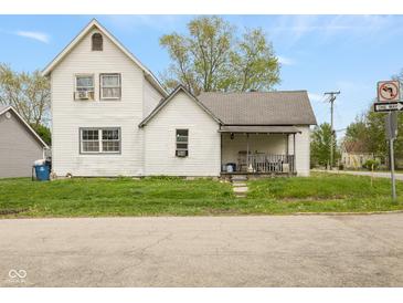 Quaint two-story home featuring a covered porch and a classic white exterior on a green lawn at 907 S Ohio St, Sheridan, IN 46069