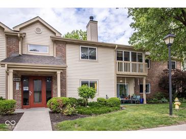 Charming condo with inviting entryway, balcony, and manicured lawn offering a cozy outdoor living space at 1046 Timber Creek Dr # 3, Carmel, IN 46032