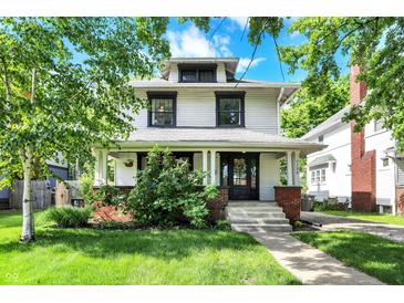 Charming two-story home with a covered porch and a well-manicured front yard at 1124 E 35Th St, Indianapolis, IN 46205