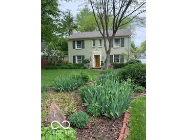 Charming home with a well-manicured front yard and mature trees creating a serene and inviting curb appeal at 1138 E 58Th St, Indianapolis, IN 46220
