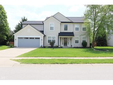 Charming two-story home with a well-manicured lawn and attached two-car garage at 12115 Flagstone Dr, Fishers, IN 46037