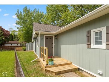 Charming home featuring a wooden porch, blue flower pot, and visible house number at 129 Rosewood Dr, Cicero, IN 46034