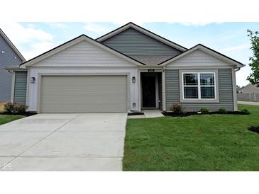 Charming one-story home featuring a well-manicured lawn and attached two-car garage at 1400 Bluebonnet Pl, Shelbyville, IN 46176