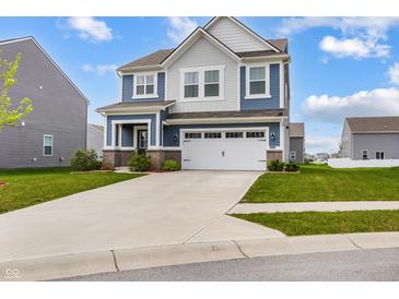 Charming two-story home features a two-car garage, blue and gray siding, and a well-manicured lawn at 1464 Buckland Ct, Avon, IN 46123