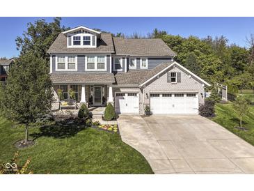 Beautiful two-story home with a three-car garage and a covered front porch at 15378 Dorman Ct, Fishers, IN 46040