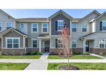 Charming townhome featuring neutral siding, brick accents, and a well-manicured lawn at 17237 Rancorn Pl, Westfield, IN 46074