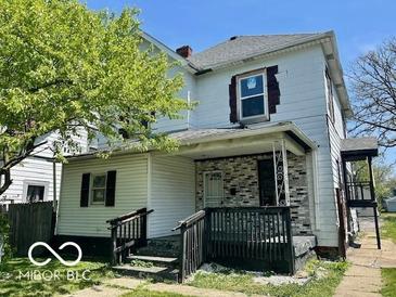 Two-story home showcasing a covered porch and a partially brick facade at 2701 N Gale St, Indianapolis, IN 46218