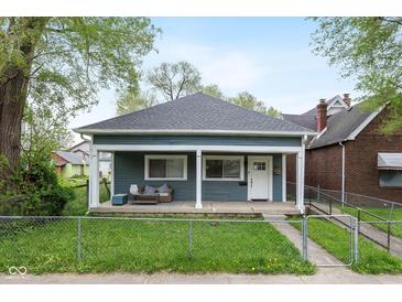 Charming single story home with a cozy front porch and well maintained lawn and landscaping at 33 N Beville Ave, Indianapolis, IN 46201