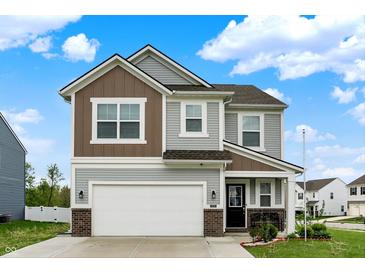 Charming two-story home featuring a two-car garage, landscaped yard and a welcoming front porch at 3719 Lexham Ct, Danville, IN 46122