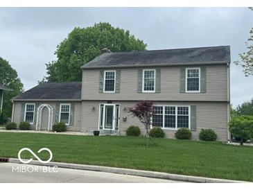 Charming two-story home featuring a well-manicured lawn and classic architectural design at 3829 Waycross Dr, Columbus, IN 47203