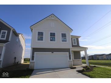 Charming two-story home with a two-car garage and a well-maintained lawn in a desirable neighborhood at 6219 Medina Spirit Dr, Indianapolis, IN 46237