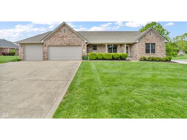 Charming brick home featuring an attached two-car garage and a well-manicured front lawn at 802 Echo Trl, Martinsville, IN 46151
