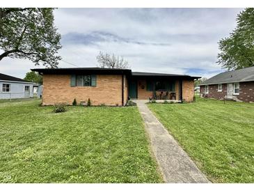 Charming single-story brick home featuring a well-maintained lawn and inviting front walkway at 100 Lincoln St, Plainfield, IN 46168