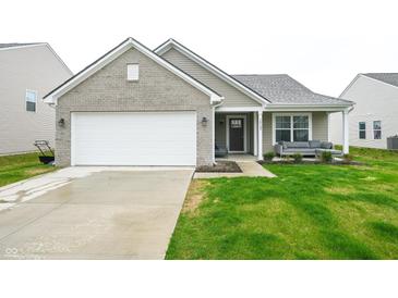 Charming single-story home with a two-car garage and inviting front porch at 10107 Camp Creek Way, Indianapolis, IN 46229