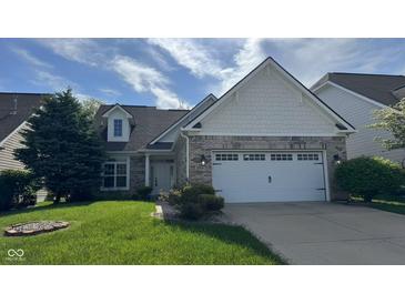 Charming home featuring a brick facade, dormer window and well-manicured front lawn at 12551 Hawks Landing Dr, Fishers, IN 46037