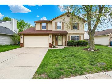Inviting two-story home with a well-maintained lawn and attached two-car garage at 12984 Shandon Ln, Fishers, IN 46038