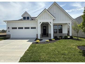 Charming two-story home with a well-manicured lawn and a two-car garage at 13355 Seven Springs Ln, Noblesville, IN 46060