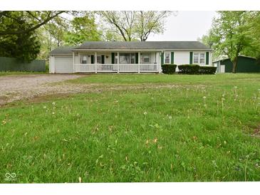 Charming single story home with a front porch and spacious lawn at 1425 E Us Highway 40, Clayton, IN 46118