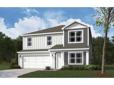 Charming two-story home featuring a two-car garage, gray siding, and white trim for a modern curb appeal at 1428 Aster Dr, Shelbyville, IN 46176
