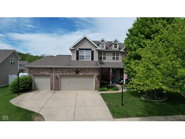 Two-story home with a three-car garage, brick facade, and well-manicured lawn at 18247 Kinder Oak Dr, Noblesville, IN 46062