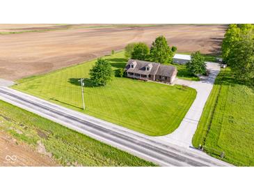 Sprawling property featuring a charming home, large lawn, and outbuilding nestled amidst picturesque farmland at 2221 W County Road 500 N, Danville, IN 46122