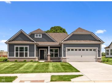 Charming one-story home with gray siding, manicured lawn, and a two-car garage at 4076 Berry Chase Blvd, Greenwood, IN 46143