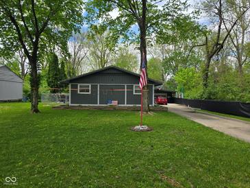 Charming single-story home with a spacious front yard, American flag, and an inviting atmosphere at 4644 N Ritter Ave, Indianapolis, IN 46226