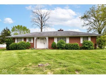 Charming single story brick home with well-manicured landscaping and white shutters on the front windows at 5101 Dickson Rd, Indianapolis, IN 46226