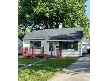 Charming single-story home featuring a red porch, well-maintained lawn, and a detached garage at 728 Lonsvale Dr, Anderson, IN 46013