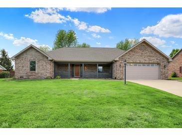 Charming one-story brick home featuring a well-maintained lawn and a covered front porch at 815 Stewart Rd, Anderson, IN 46012