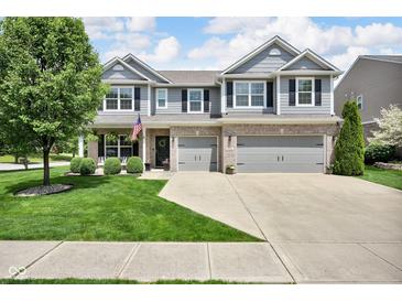 Beautiful two-story home with a brick and siding exterior, mature tree, and manicured lawn at 8704 New Heritage Dr, Indianapolis, IN 46239