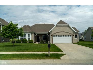 Well-maintained home with attached two car garage, brick facade, and a landscaped front yard at 8732 Wicklow Way, Brownsburg, IN 46112