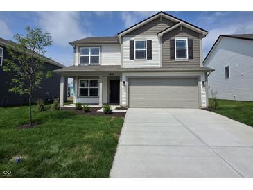Charming two-story home featuring a two-car garage and a well-manicured lawn at 11302 N Quillow Way, Monrovia, IN 46157