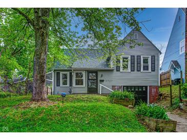 Charming two-story home with a well-maintained lawn, mature trees, and a welcoming front entrance at 1717 W 10Th St, Anderson, IN 46016