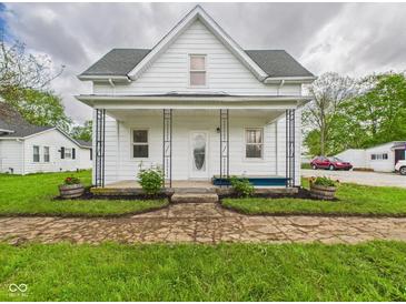 Charming home featuring a covered front porch and well-maintained front yard landscaping at 225 S Carthage Rd, Charlottesville, IN 46117