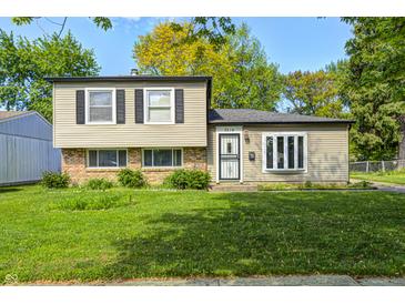 Charming two-story home with a well-maintained lawn and a mix of brick and siding exterior at 3514 Eisenhower Dr, Indianapolis, IN 46224