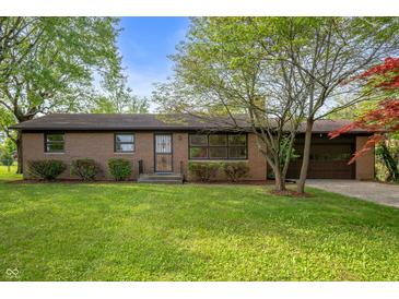 Charming brick ranch with manicured lawn, mature trees, and attached two-car garage at 3605 Redfern Dr, Indianapolis, IN 46237