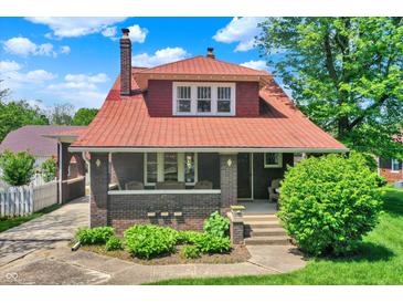 Charming two-story home with a brick facade, covered front porch, and well-manicured landscaping at 3744 S Meridian St, Indianapolis, IN 46217
