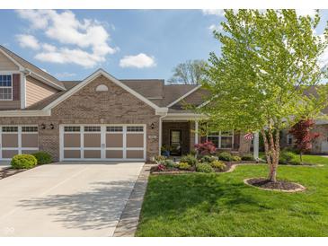 Charming brick home with well-manicured lawn, two-car garage, and a welcoming front porch at 4281 Cairo Way, Avon, IN 46123