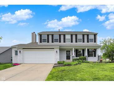 Charming two-story home featuring white-painted brick, a well-manicured lawn, and inviting curb appeal at 6624 Lakestone Ct, Indianapolis, IN 46237