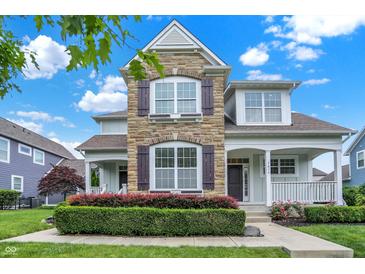 Charming two-story home with a stone facade and landscaped front yard at 7614 Bishops, Zionsville, IN 46077