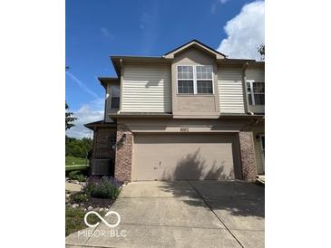 A delightful two-story home with a two-car garage, brick accents, and lush landscaping at 8002 Windham Lake Way # 33, Indianapolis, IN 46214