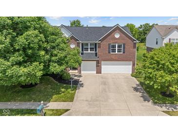 Beautiful brick two-story home with a well-manicured lawn and a spacious two-car garage at 8316 Thorn Bend Dr, Indianapolis, IN 46278