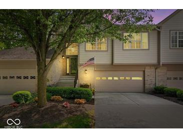Charming townhome showcasing a well-maintained front yard and inviting entrance with a garage at 9317 Muir Ln, Fishers, IN 46037