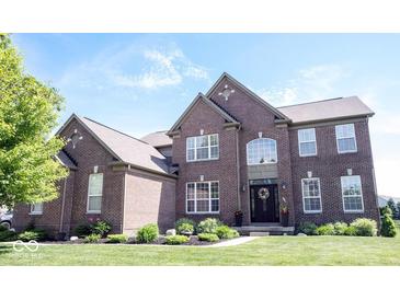 Beautiful two-story brick home featuring manicured lawn and landscaping at 10267 Ranford Blvd, Fishers, IN 46040