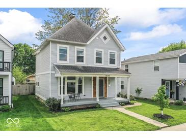 Charming two-story home with covered front porch and well-manicured lawn at 1505 Spann Ave, Indianapolis, IN 46203