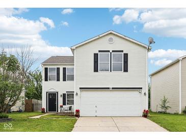 Charming two-story home featuring a large garage, manicured lawn, and classic white siding at 2545 Harvest Moon Dr, Greenwood, IN 46143