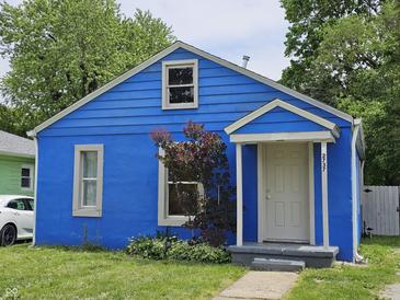 Charming blue bungalow featuring a cozy front entrance and well-maintained lawn at 2737 S Roena St, Indianapolis, IN 46241