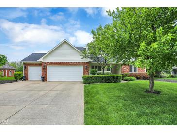 Charming brick and siding home with a well-manicured lawn and attached two-car garage at 3996 Brockton Manor N Dr, Greenwood, IN 46143